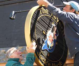 The Tavern Sign being installed