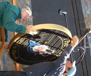 The Tavern Sign being installed